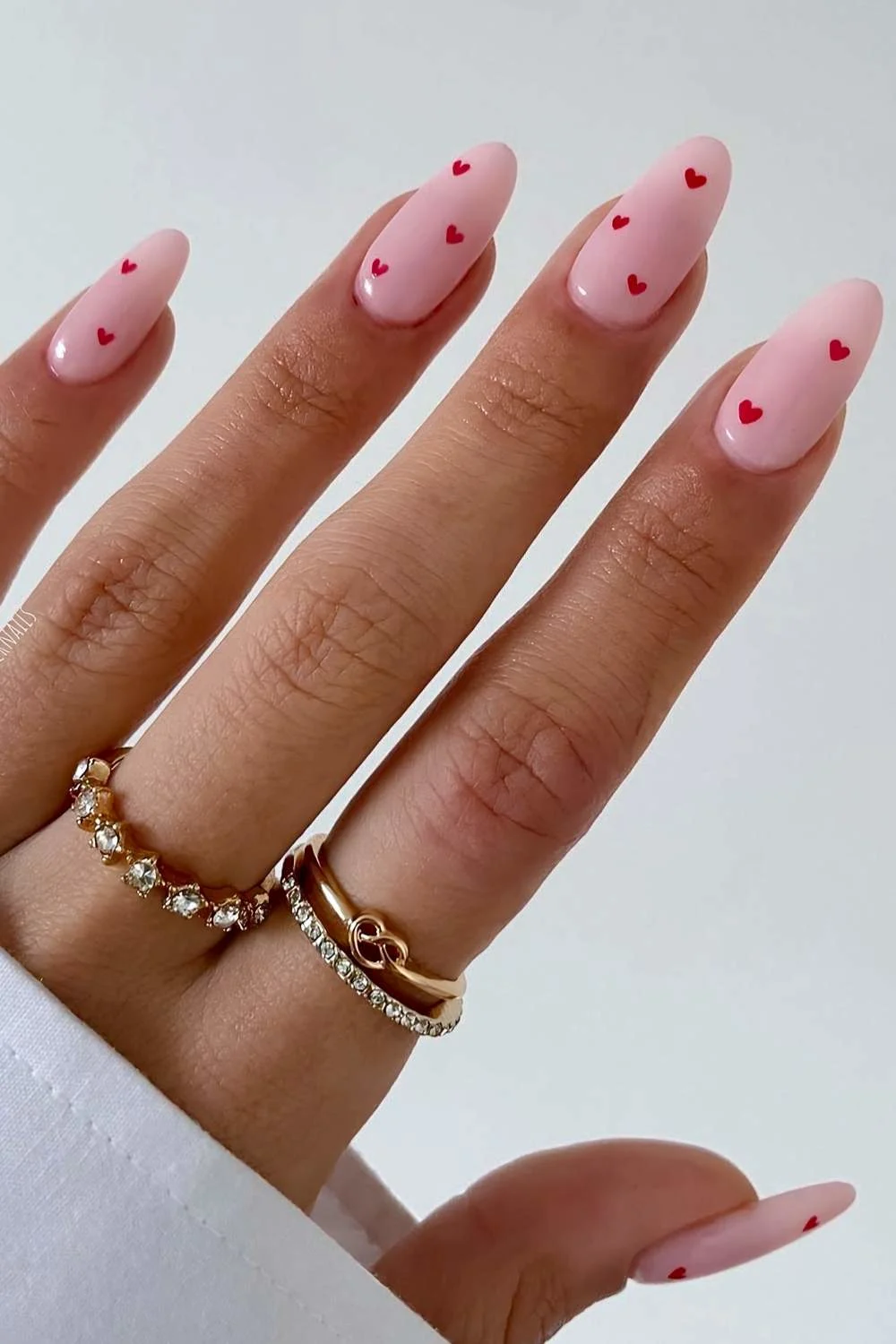 Milky pink mani with tiny red hearts