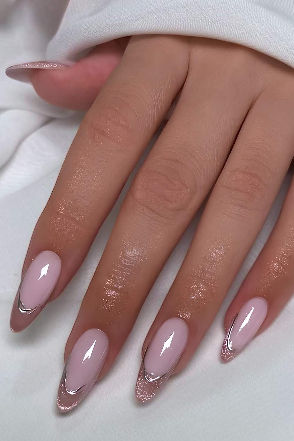 Pink cat eye French nails with silver outlines