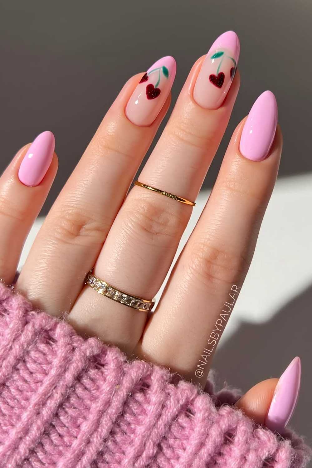 Pink nails with heart shaped cherry art