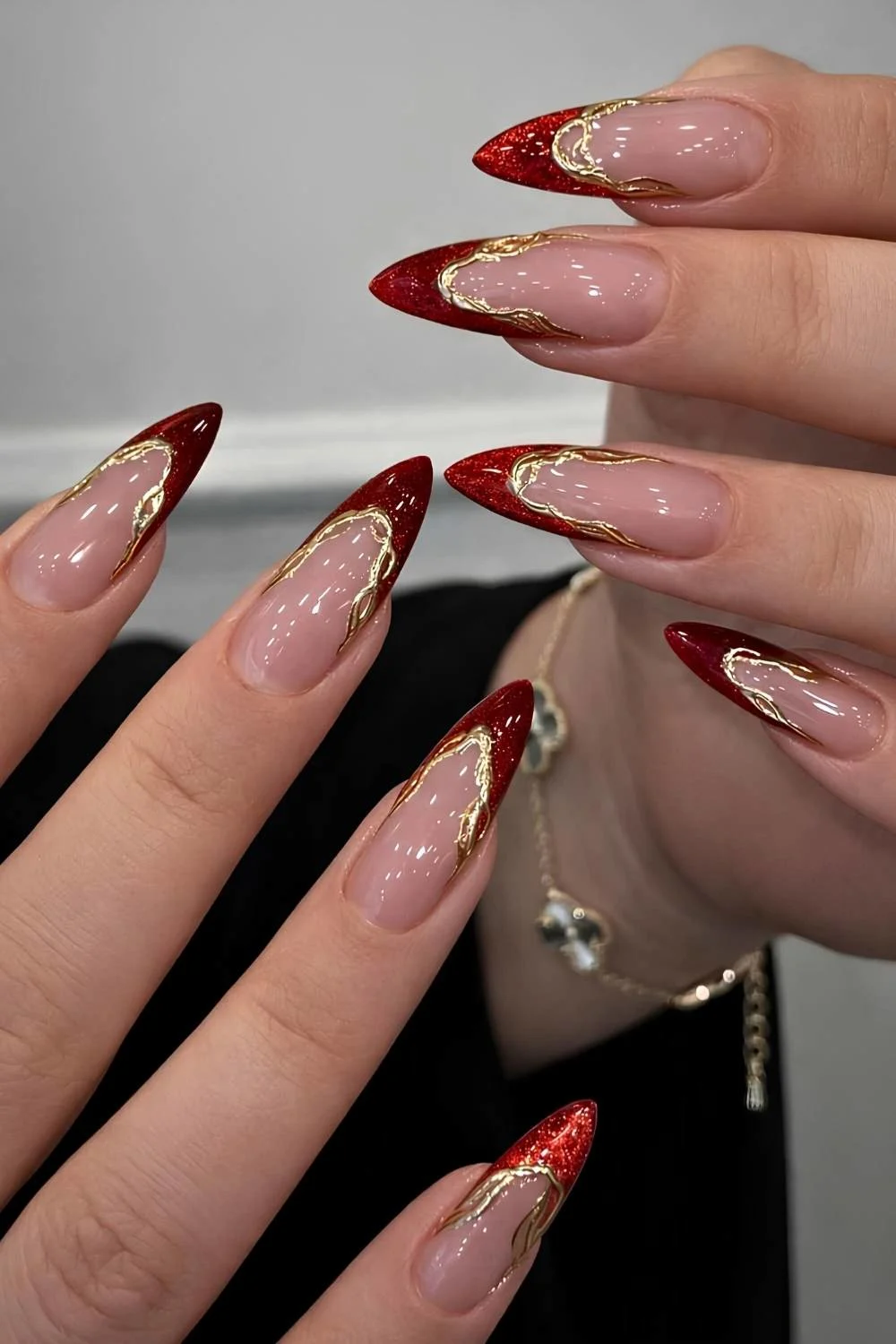 Red cat eye French nails with gold outlines