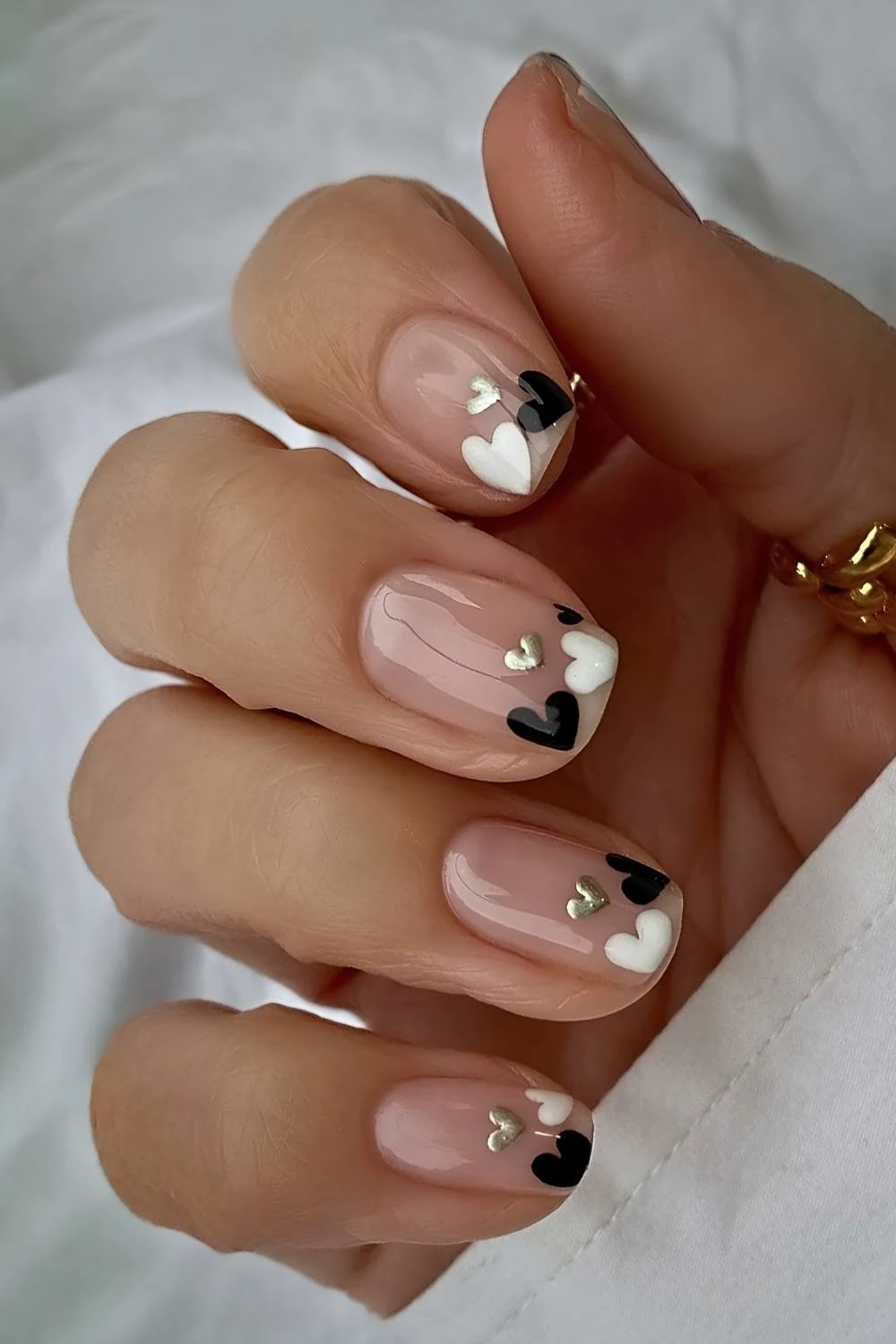 Short sheer nails with black and white hearts
