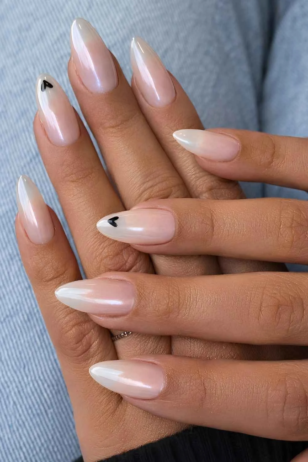 White chrome manicure with black hearts