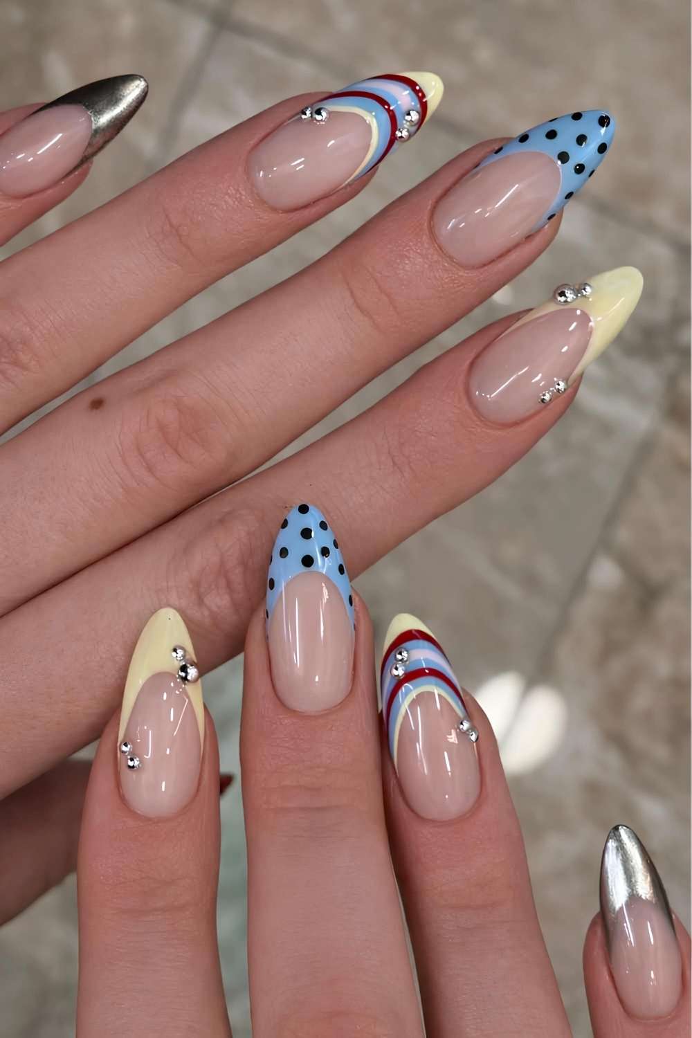 Blue and yellow nails with stripes and dots