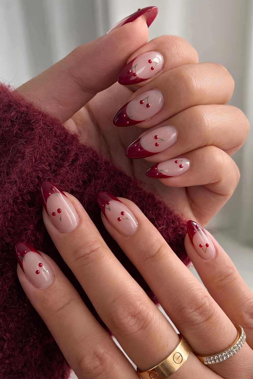 Deep red French mani with micro cherry art