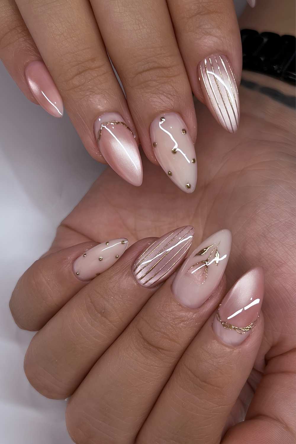 Dusty pink cat eye nails with stripes and dots