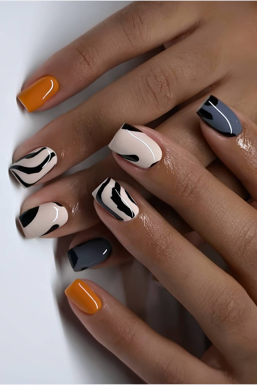 Neutral mani with animal print and orange accents
