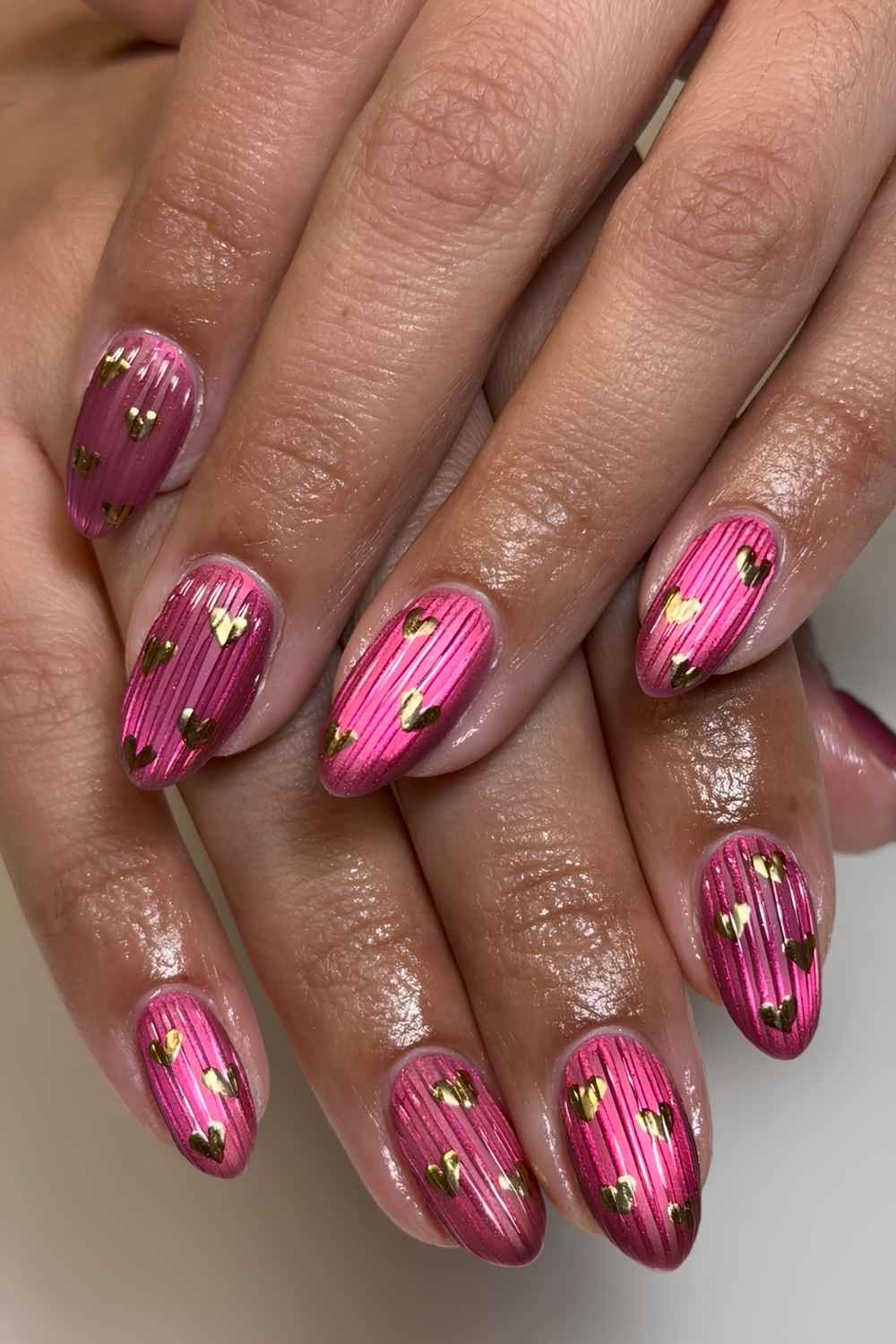 Pink ribbed glass mani with gold heart art