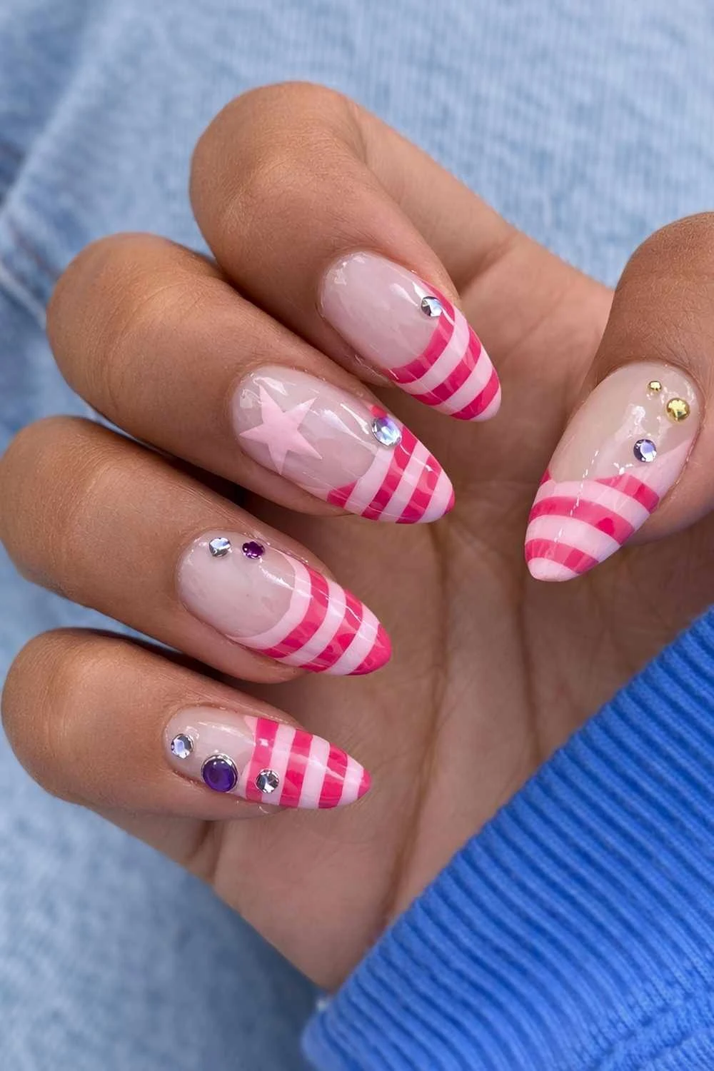 Pink striped French mani with gems and stars