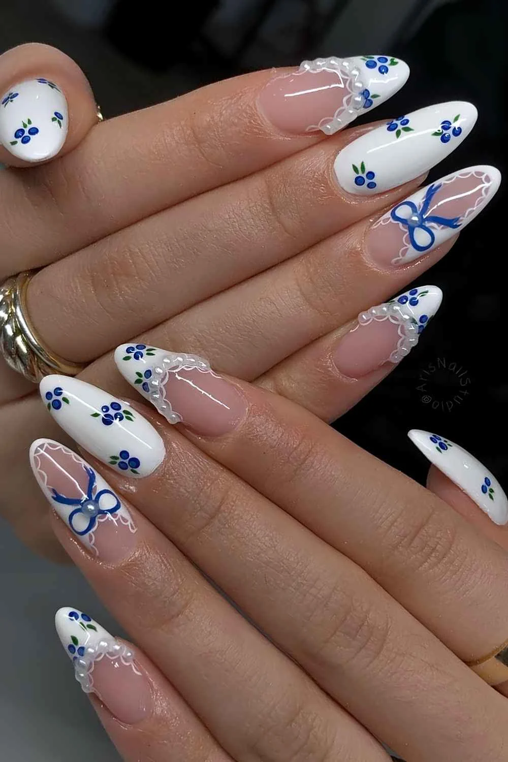 White mani with blueberry and lace art
