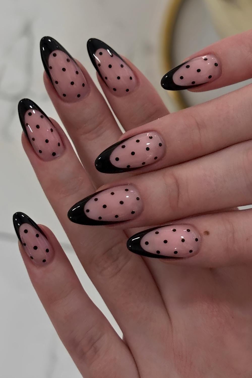 Black French tip nails with polka dots