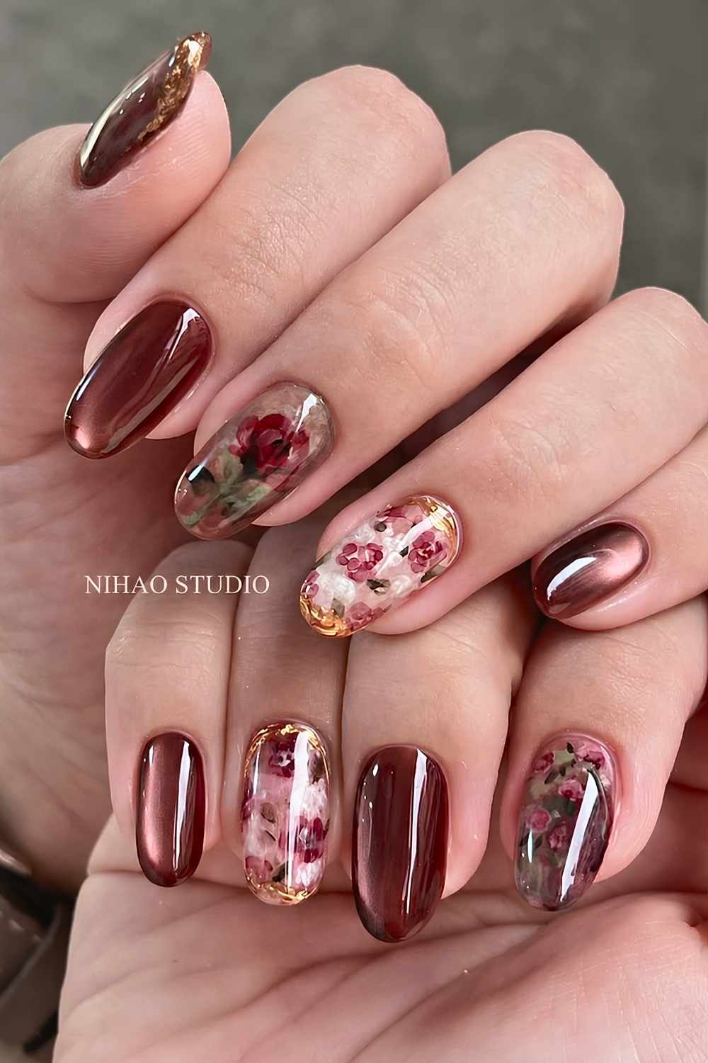 Deep red cat eye nails with rose art