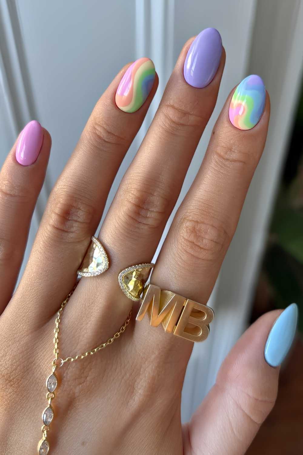 Pastel manicure with rainbow accent art
