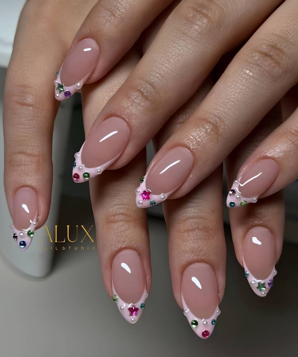 Pink French mani with colorful rhinestones