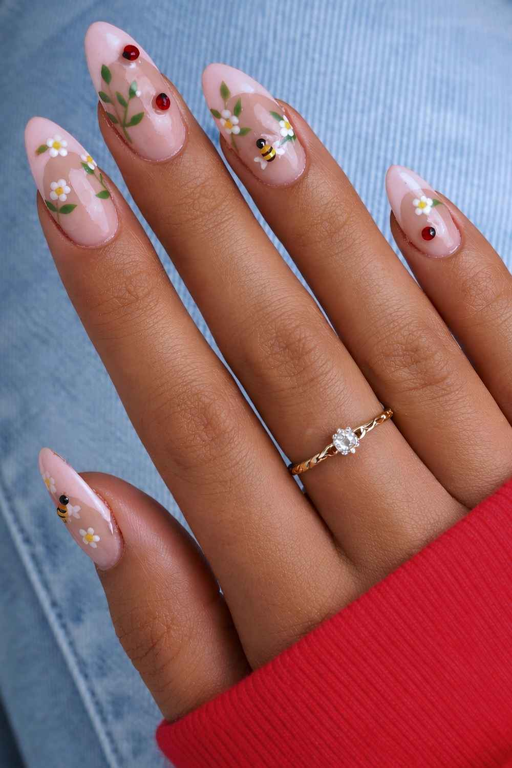 Pink French nails with bee and daisy accents