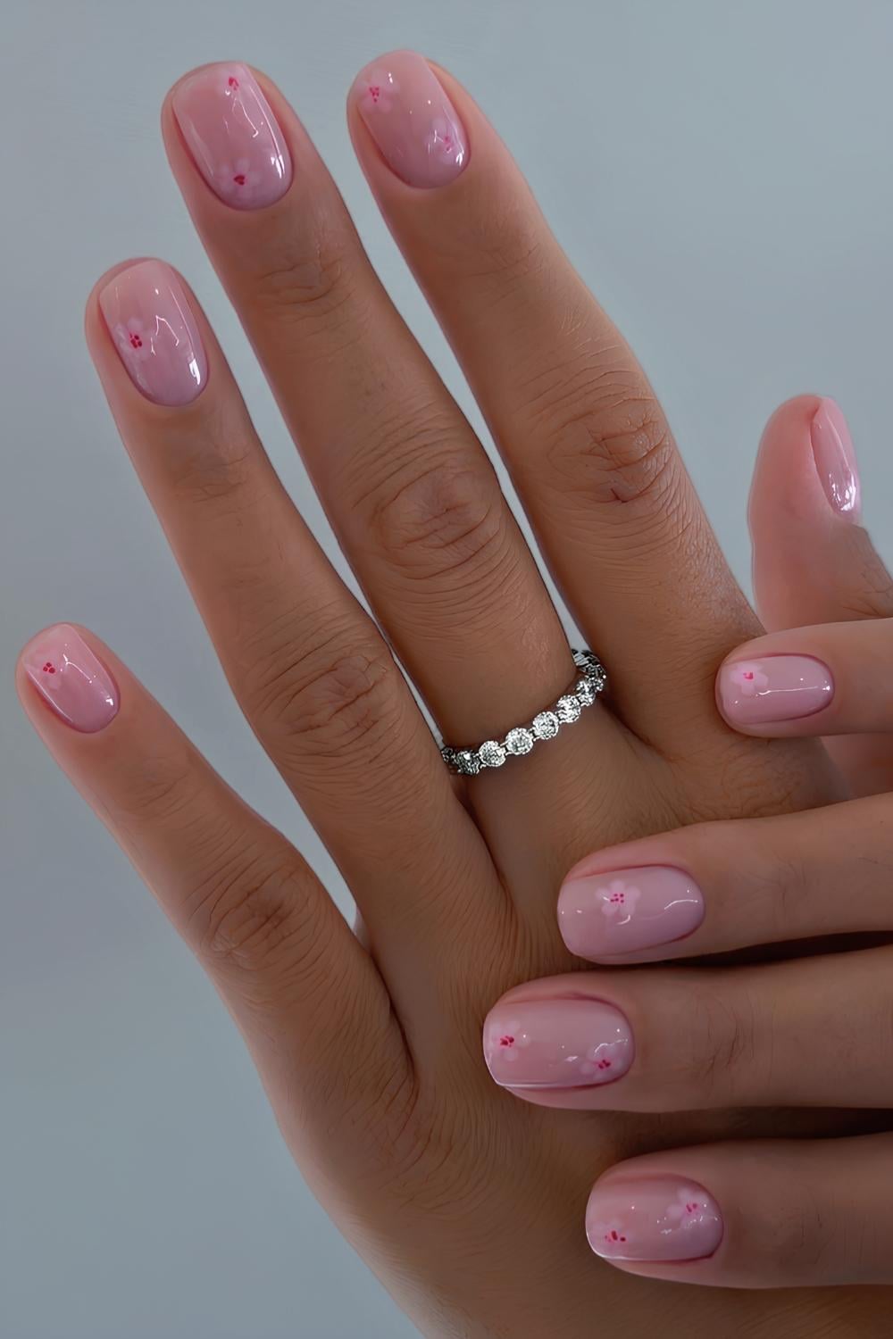 Short pink nails with cherry blossom art