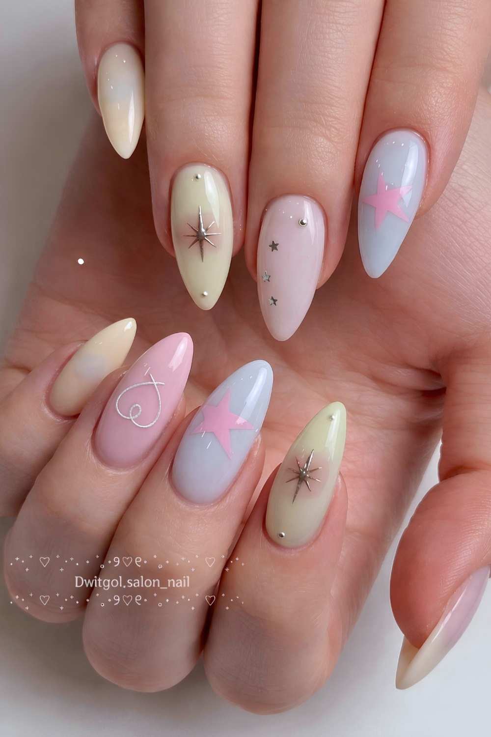 Soft pastel manicure with hearts and stars