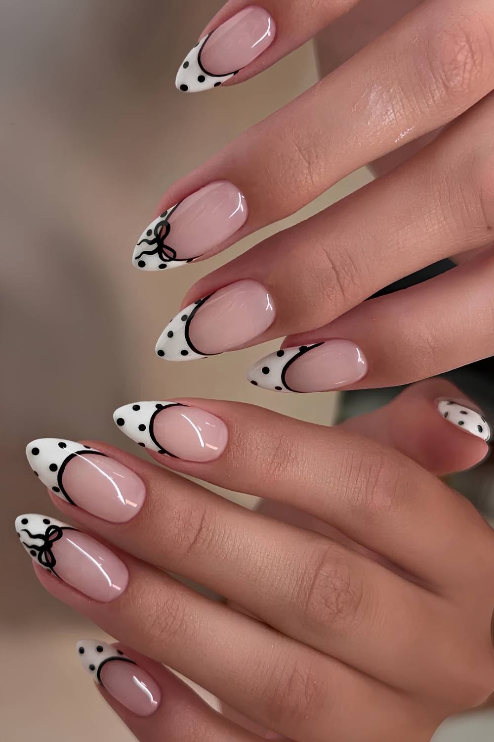 White and black polka dot French mani with accent bow