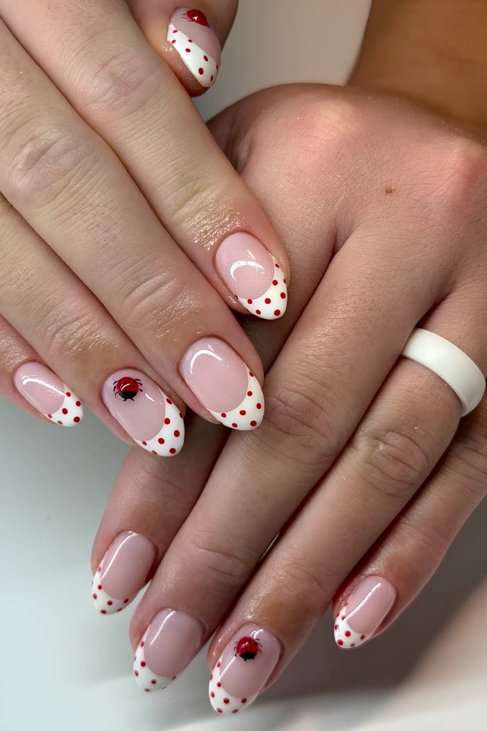 White and red polka dot French mani with ladybugs