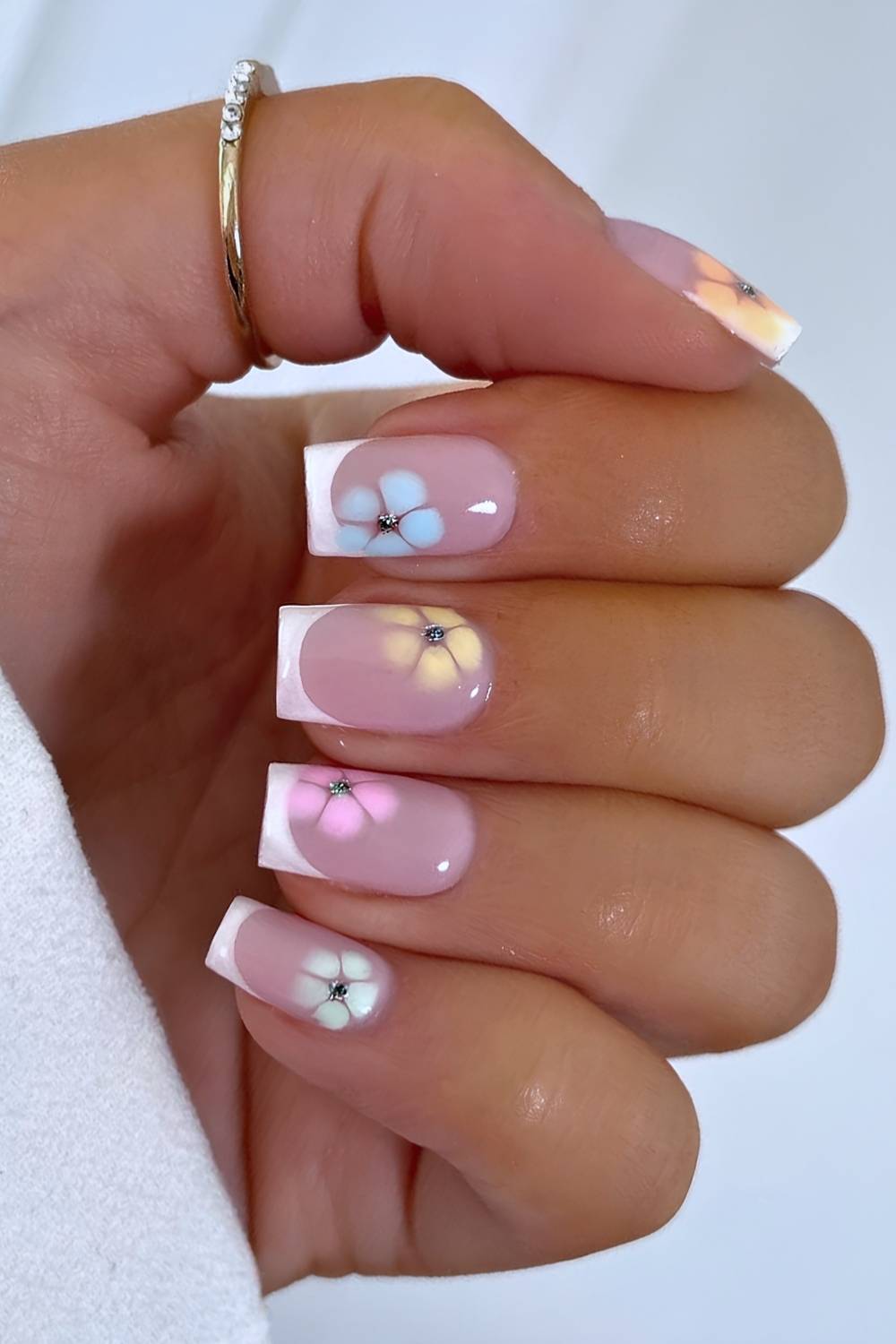 White french mani with pastel blooming gel flowers