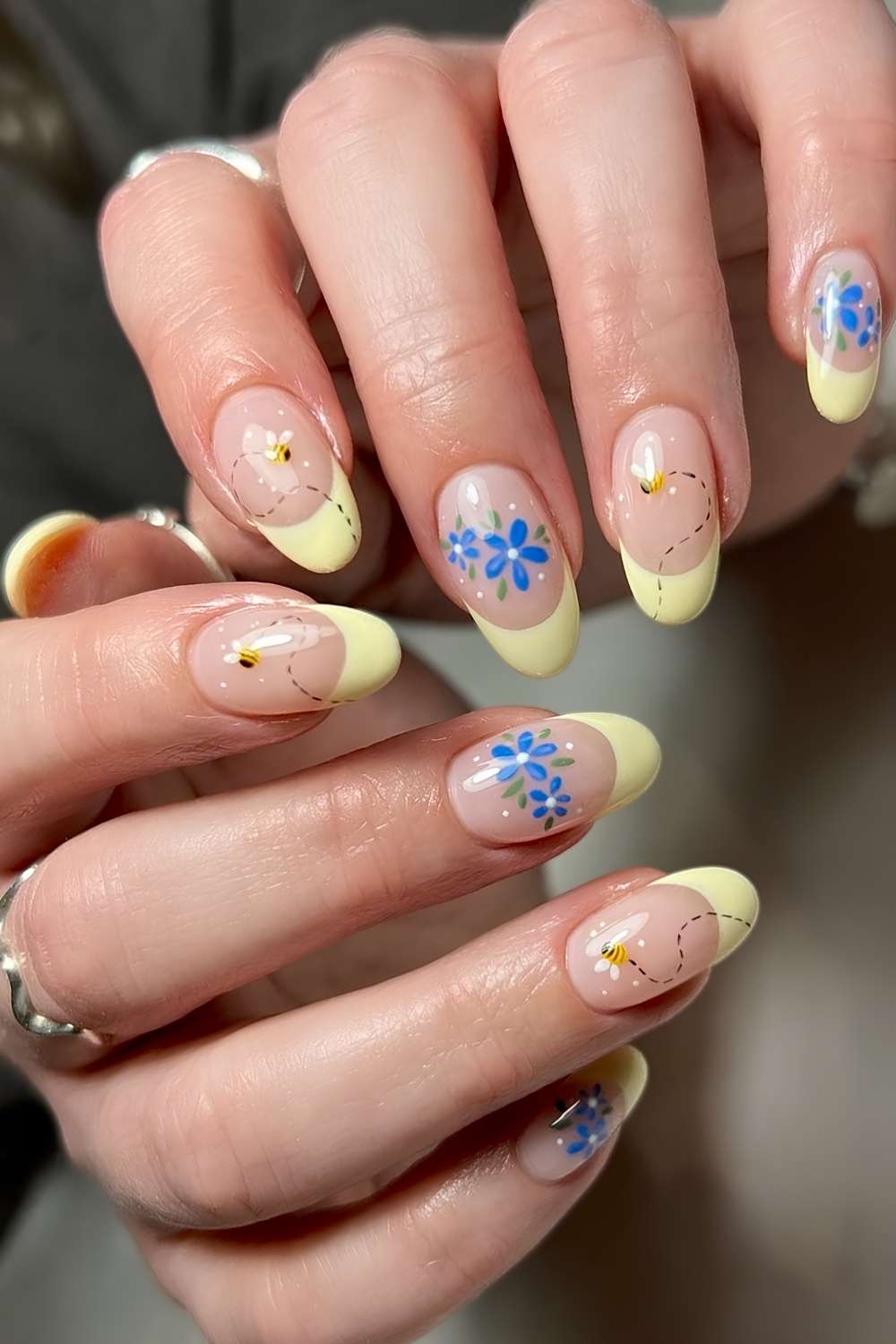 Yellow French mani with bees and blue flowers
