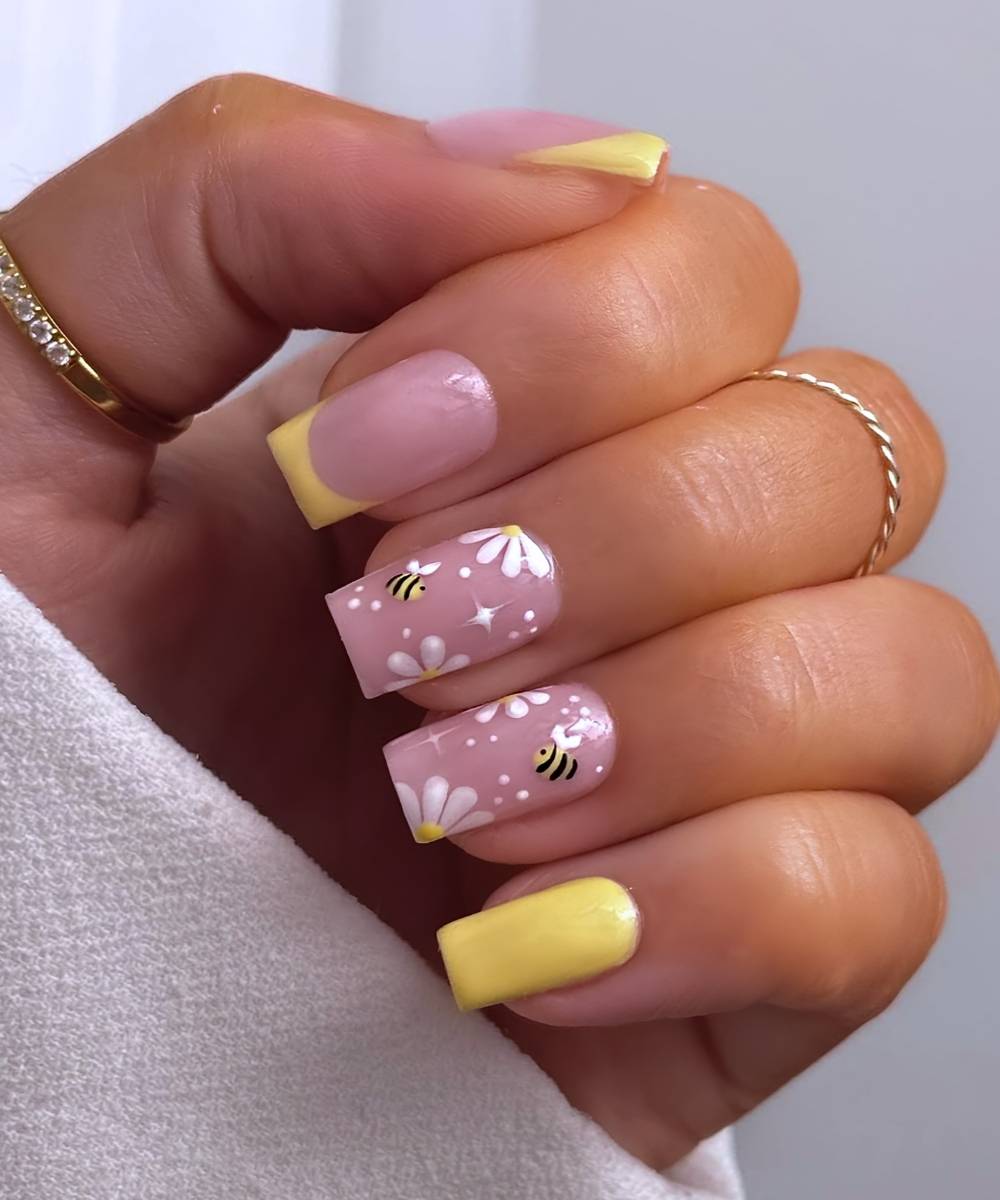 Yellow nails with bee and daisy art