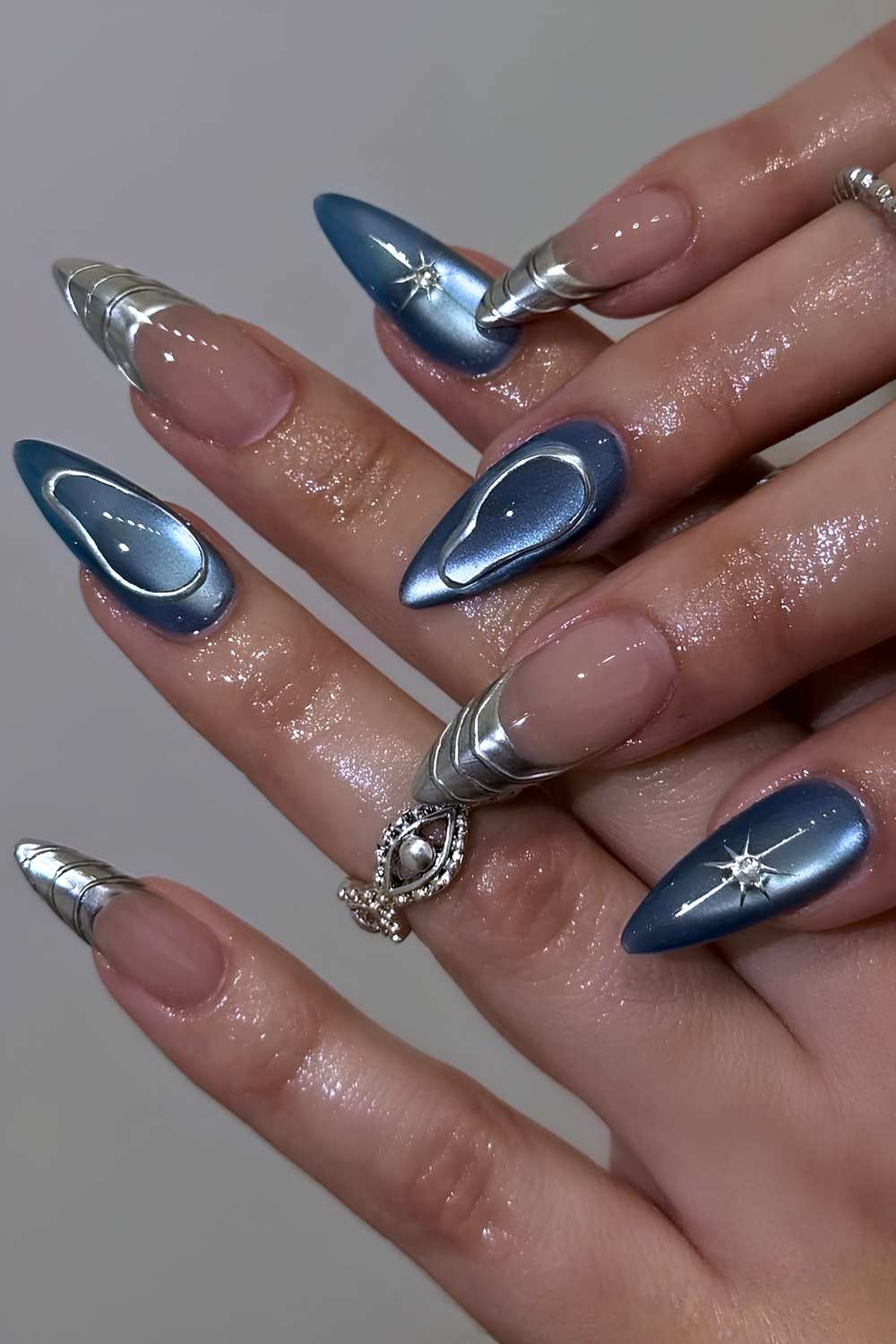Blue cat eye nails with accent silver art