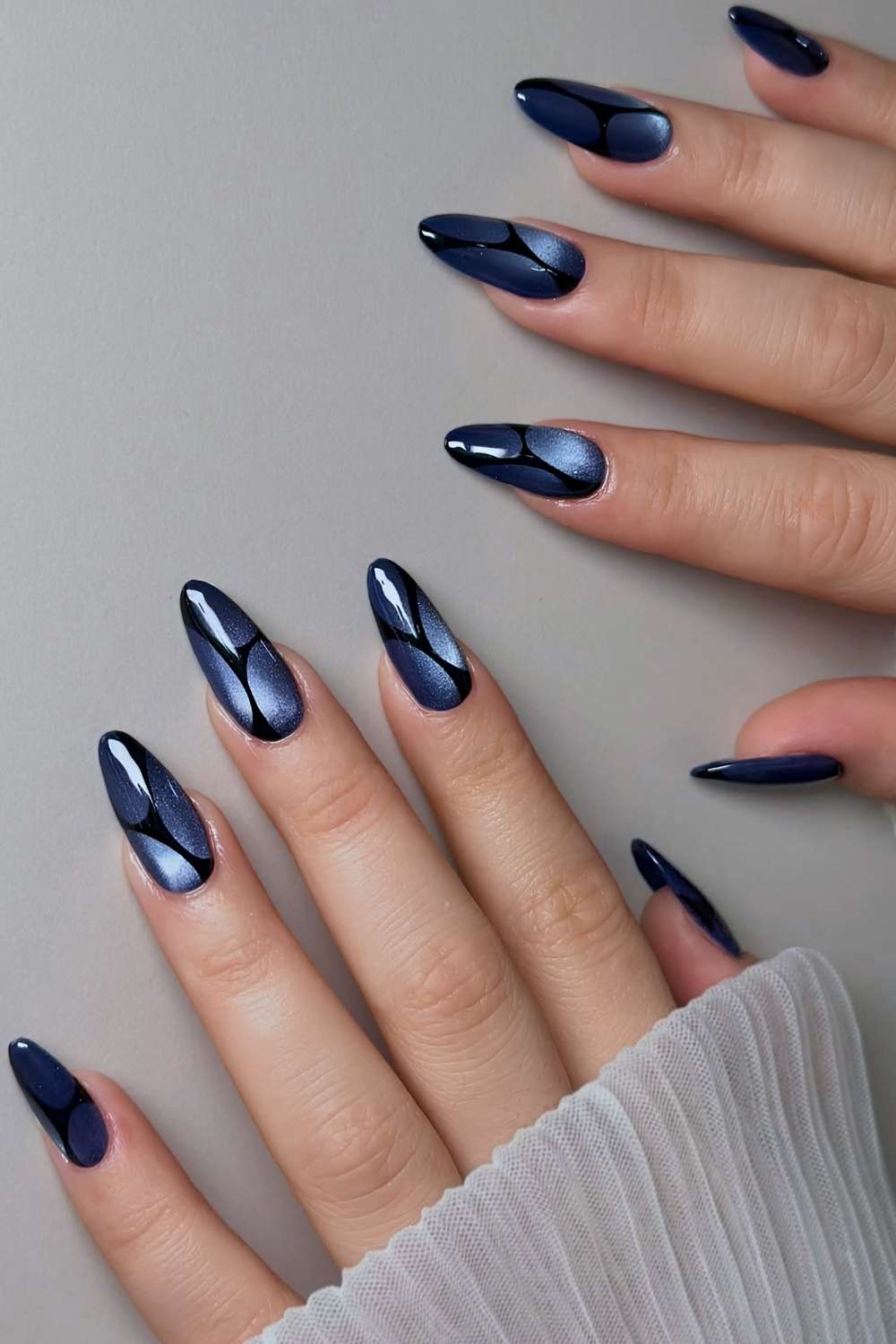 Blue cat eye nails with black line art