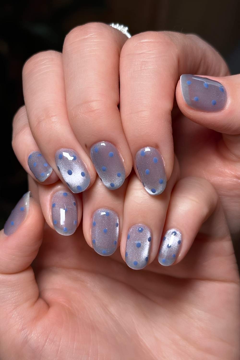 Blue cat eye nails with polka dots