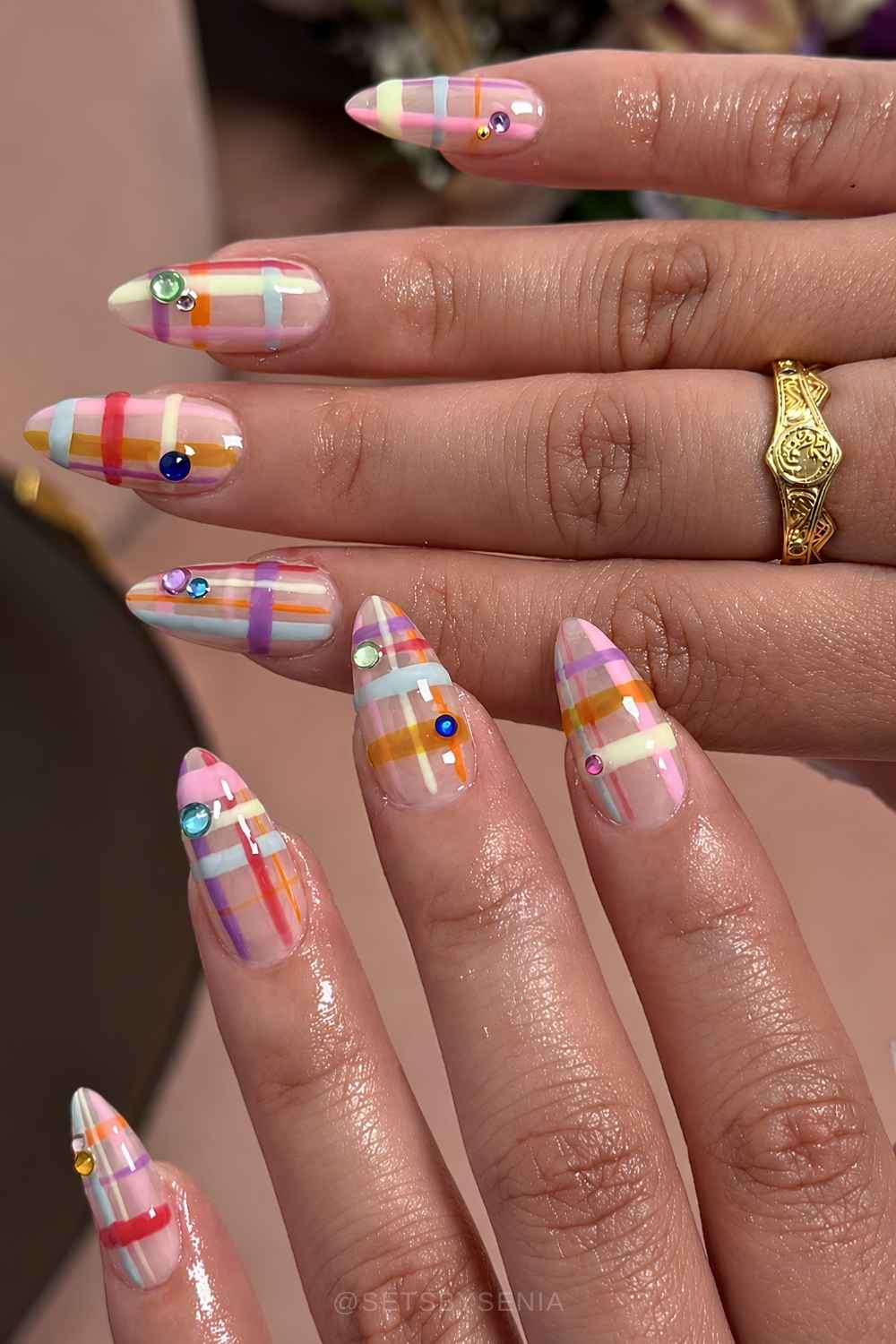 Colorful plaid nails with accent gems