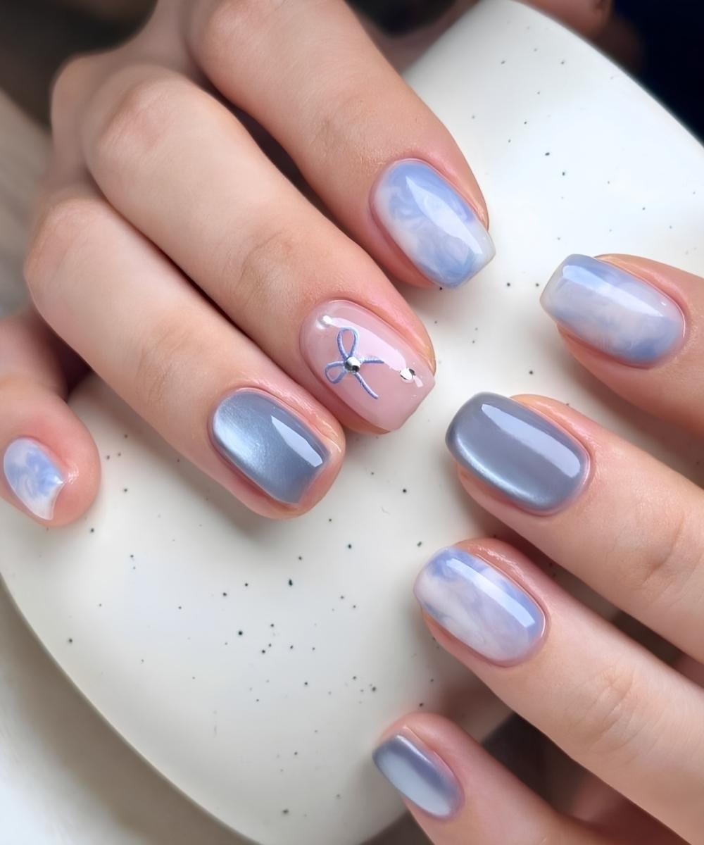Light blue cat eye mani with marble and bows