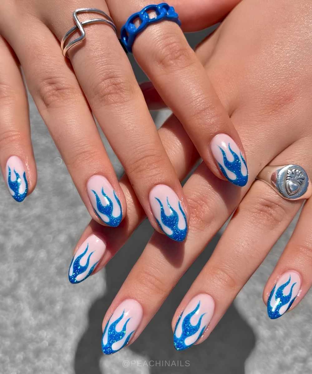 Milky nails with blue glitter flame tips