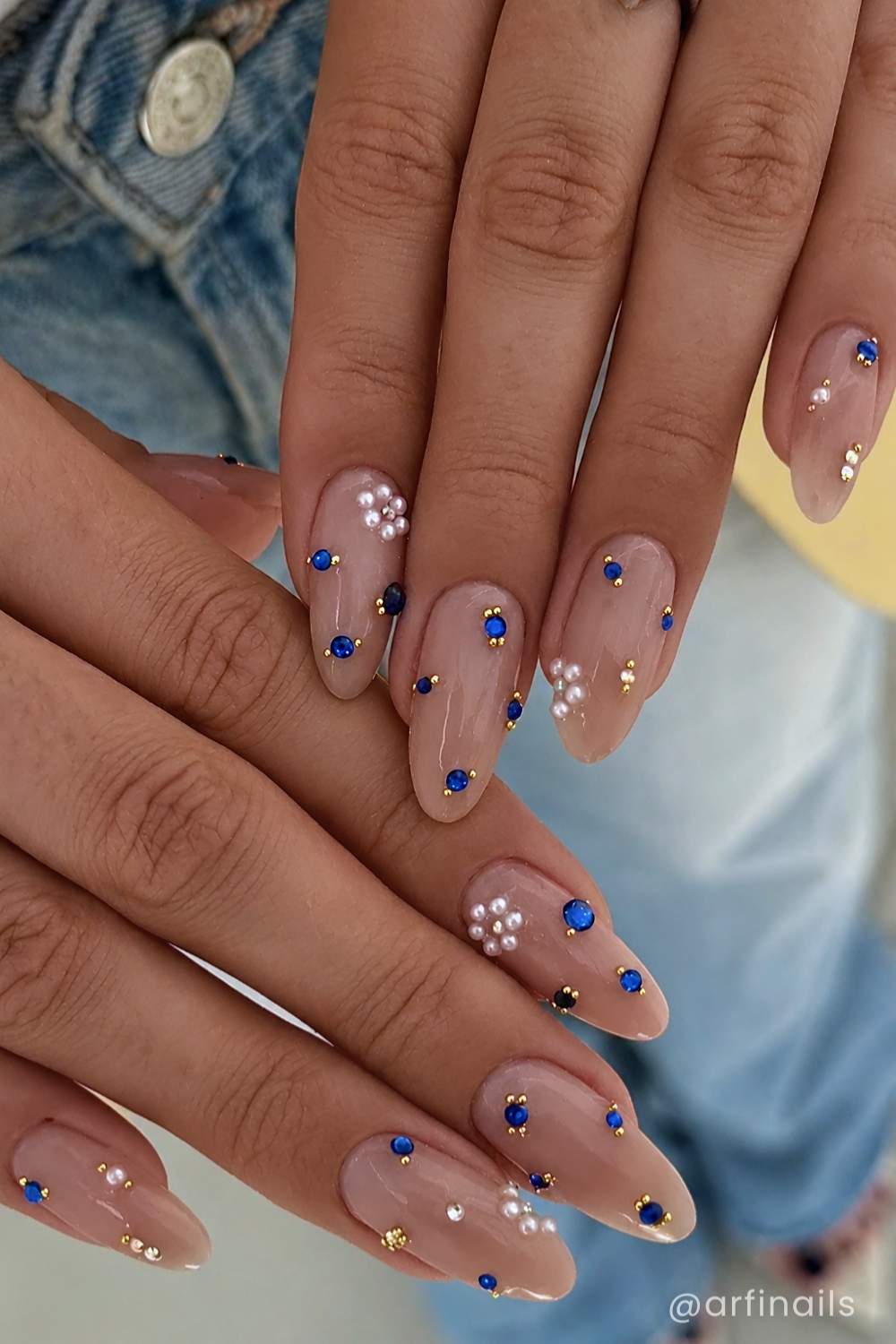 Neutral mani with blue gems and pearl flowers