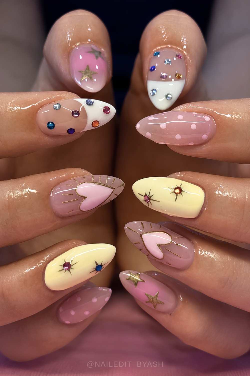 Pink and yellow nails with gems and hearts