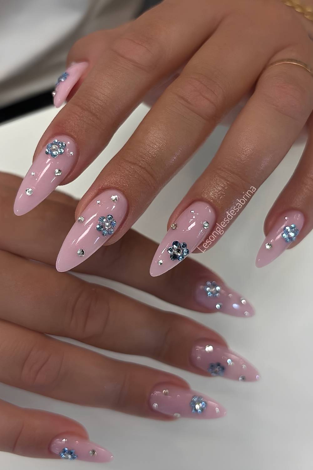 Pink mani with blue gem flowers
