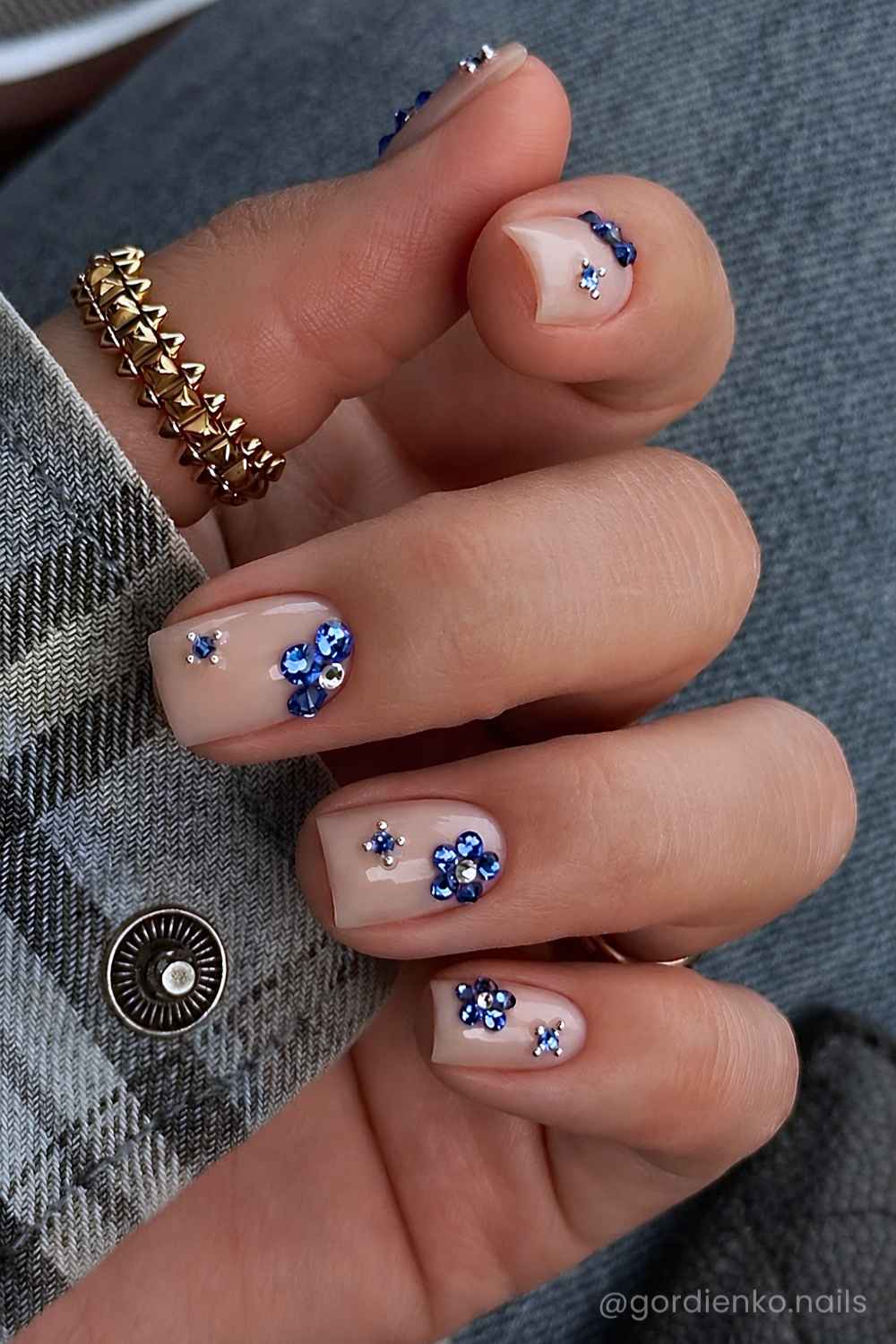 Short milky mani with blue gem florals