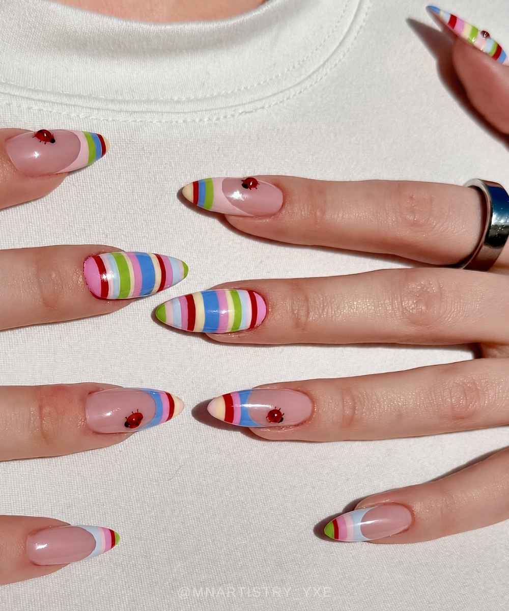 Colorful striped nails with ladybugs