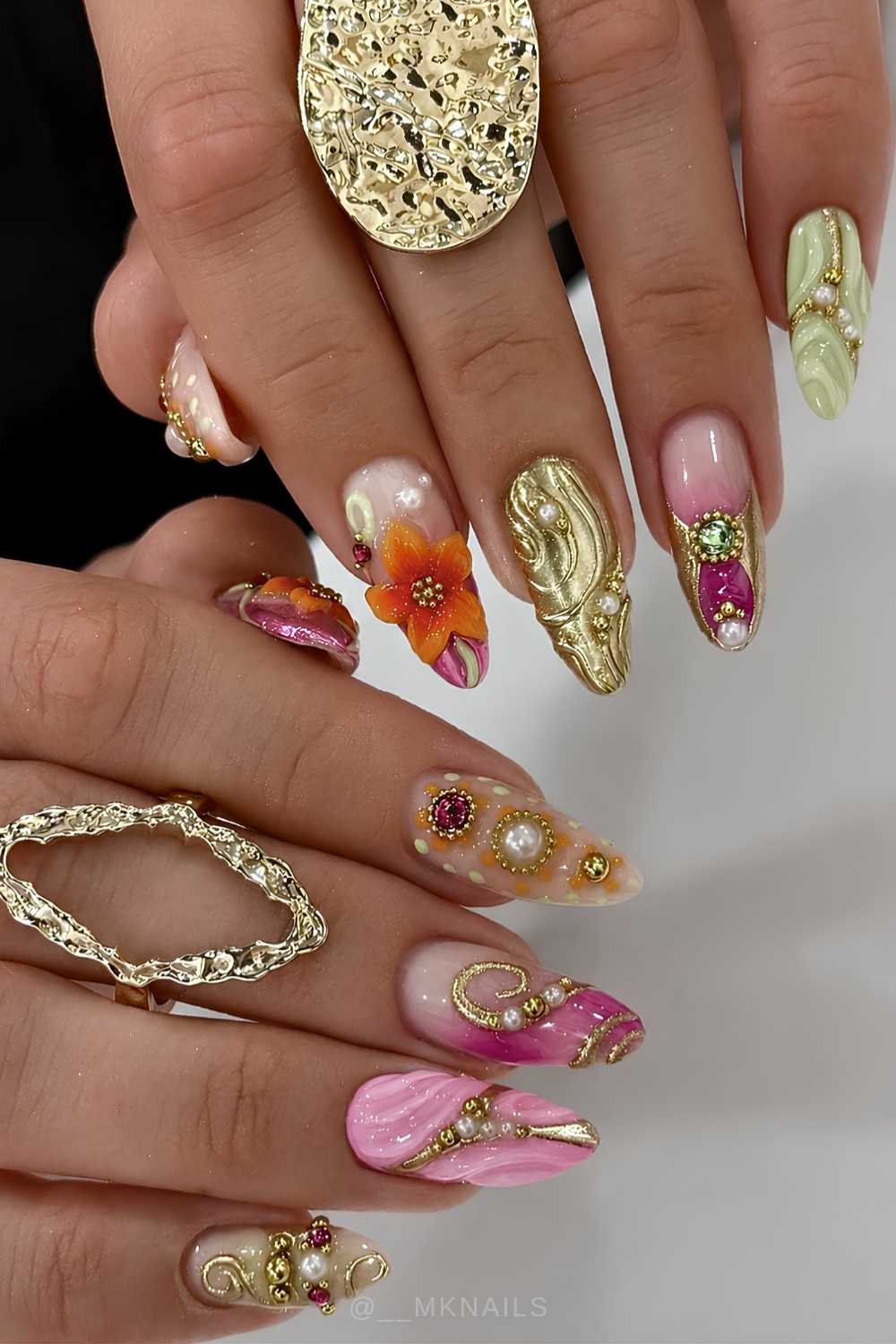 Maximalist pink and orange nails with gold accents