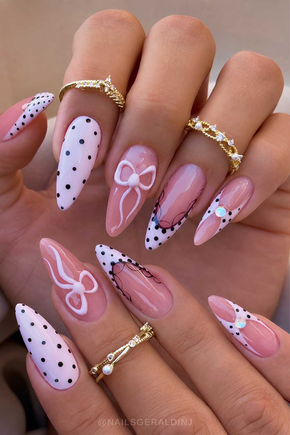 Pink and black nails with dots and bows