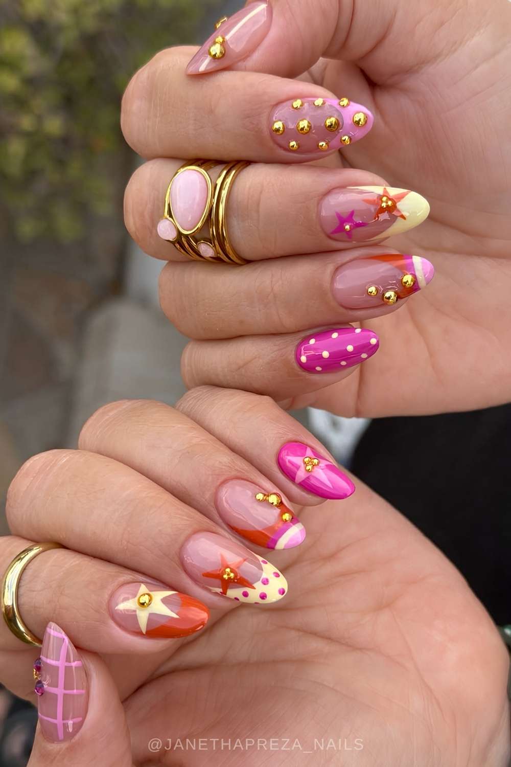 Pink and orange nails with stars and gold beads