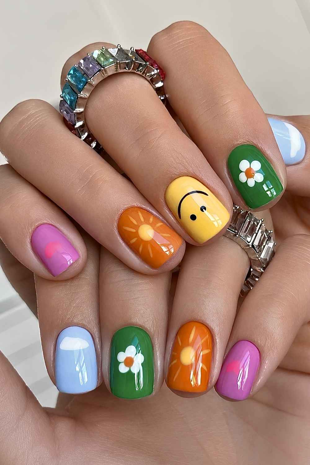 Short colorful nails with cheerful motifs