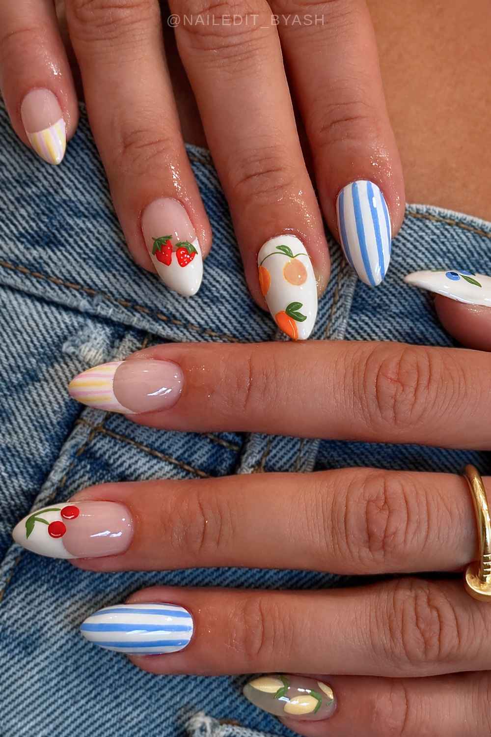 White mani with colorful stripes and fruit art