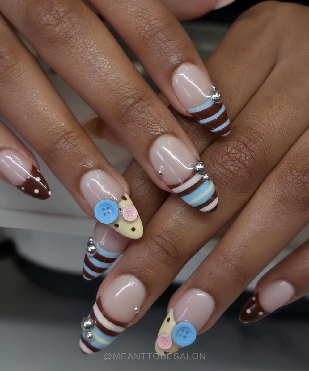 Blue brown and yellow nails with stripes and buttons