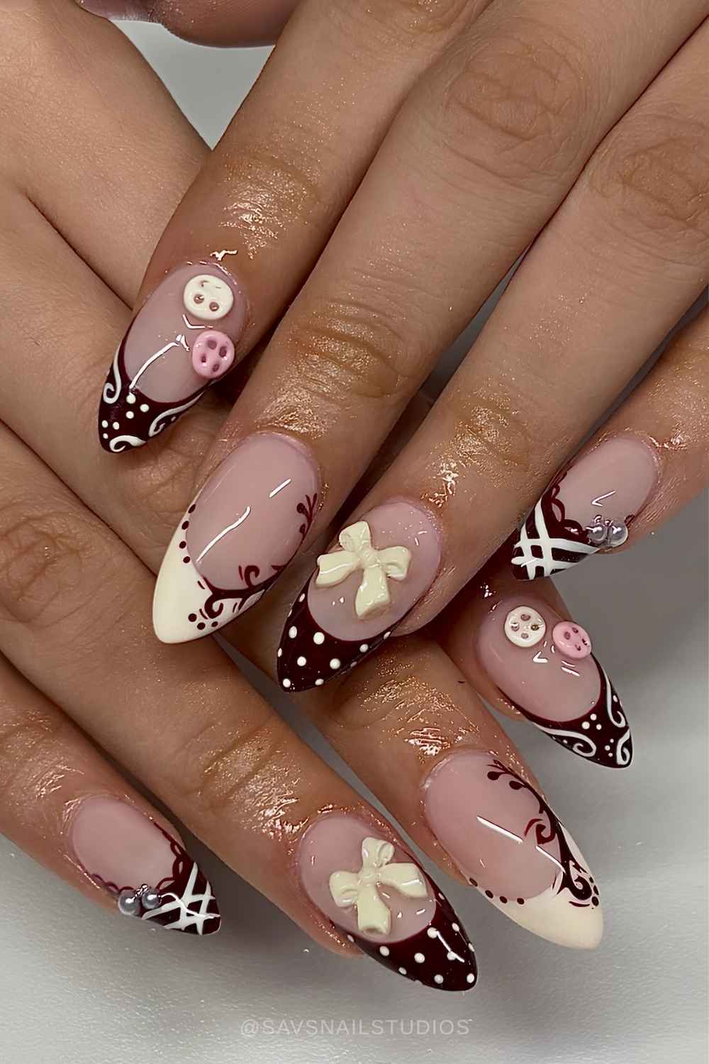 Brown and beige French mani with bows and buttons