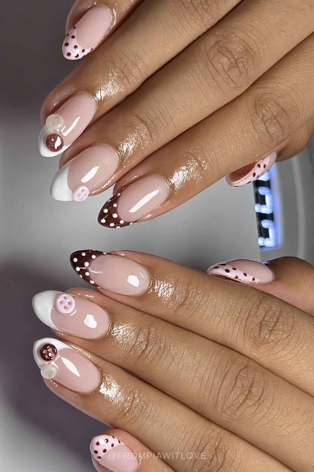 Brown and white French mani with buttons and dots