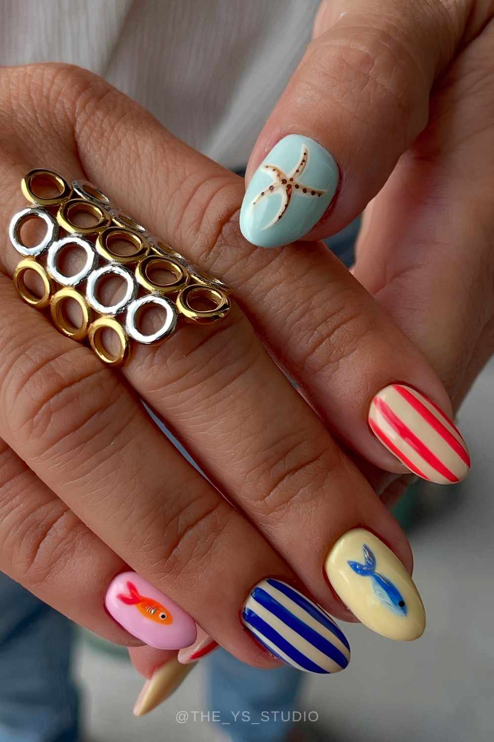 Colorful manicure with stripes and fish art