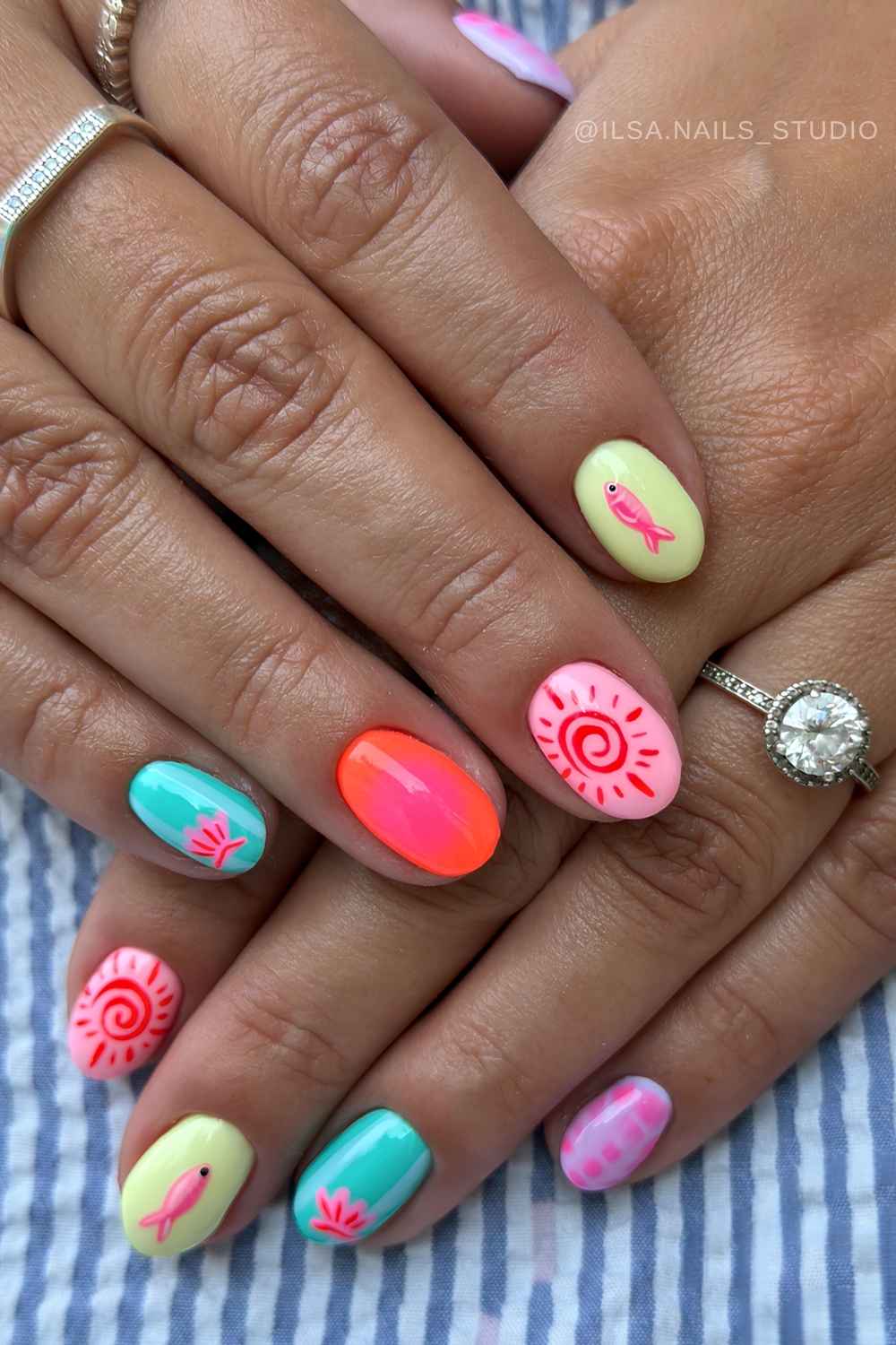 Colorful oval nails with fish and sun art