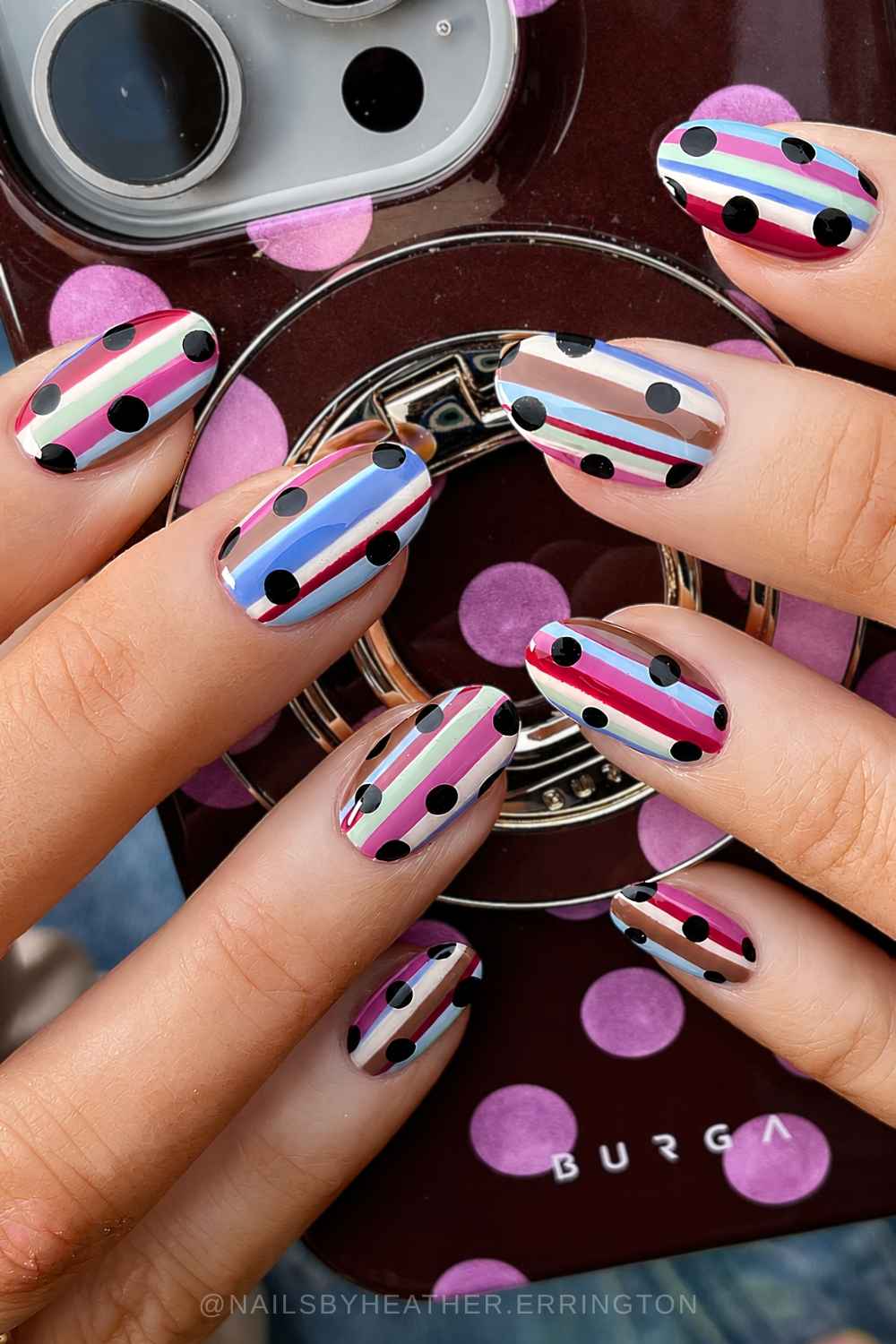 Colorful striped nails with black polka dots