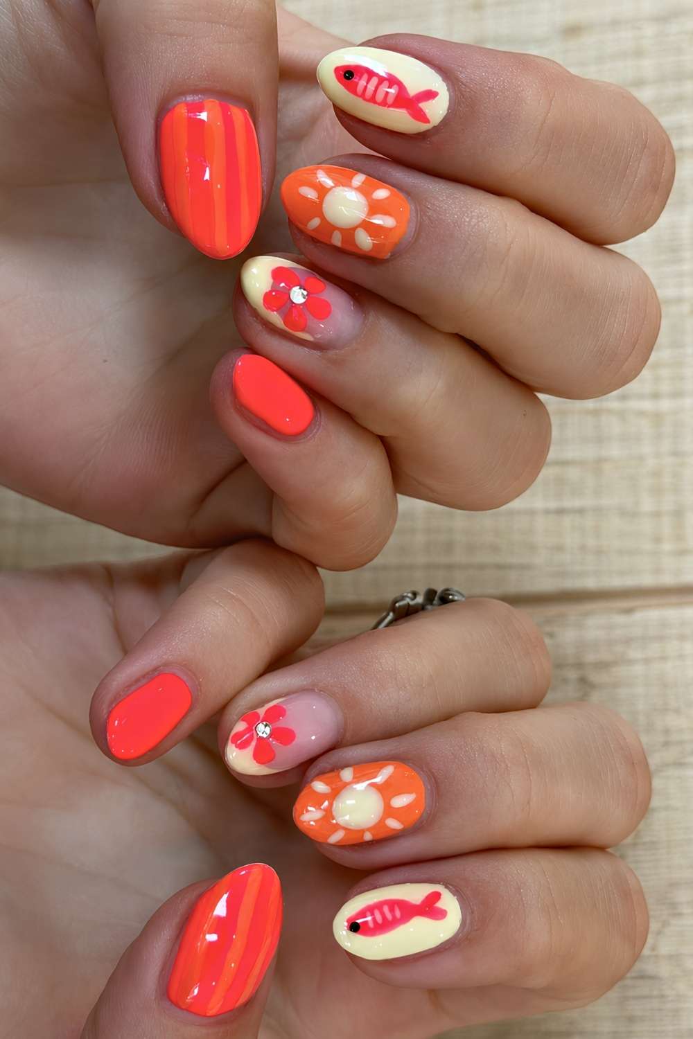 Coral and orange summer nails with fish art
