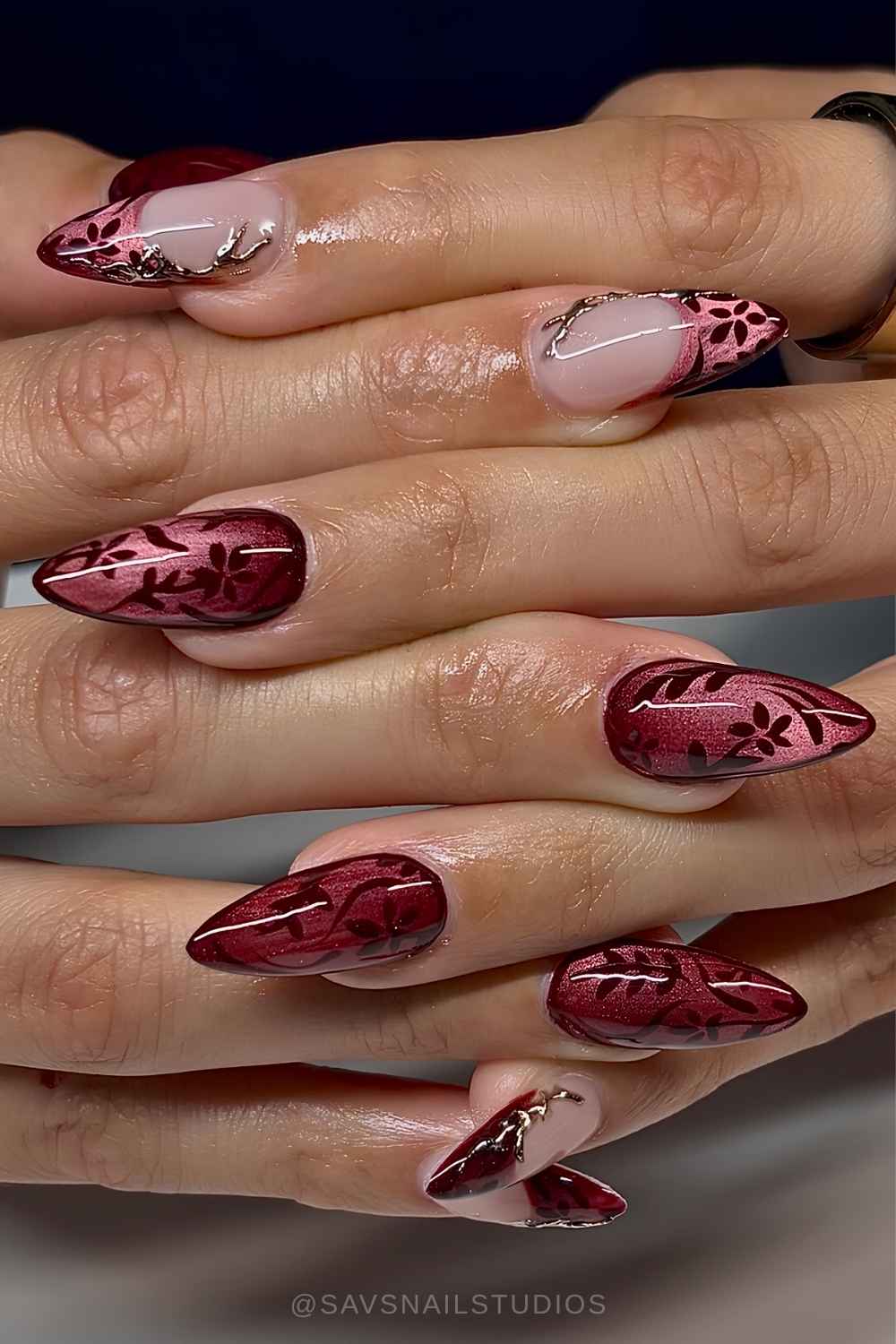 Deep red cat eye nails with floral art