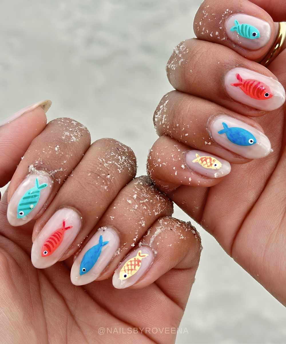 Milky white nails with colorful fish motifs